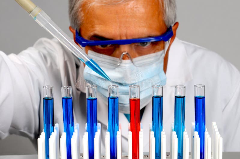 Closeup of a scientist with test tubes and pipette. Horizontal format with focus on the test tubes. Closeup of a scientist with test tubes and pipette. Horizontal format with focus on the test tubes.