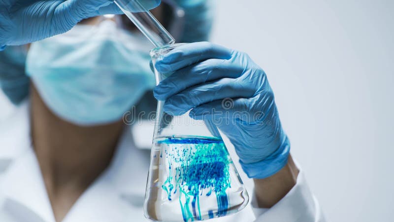 Cientista nas luvas que derramam o ácido azul no tubo de ensaio com líquido transparente imagens de stock royalty free Cientista nas luvas que derramam o ácido azul no tubo de ensaio com líquido transparente imagens de stock royalty free