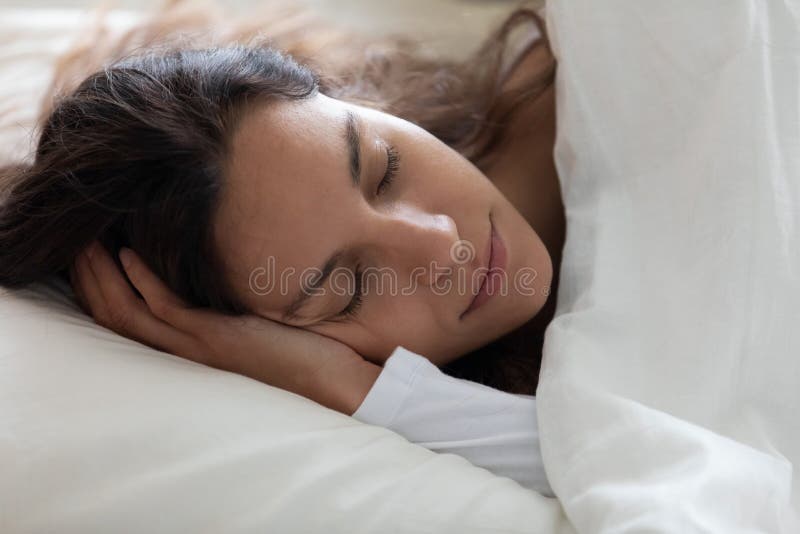 Cierra serene hermosa mujer durmiendo sola bajo una manta caliente