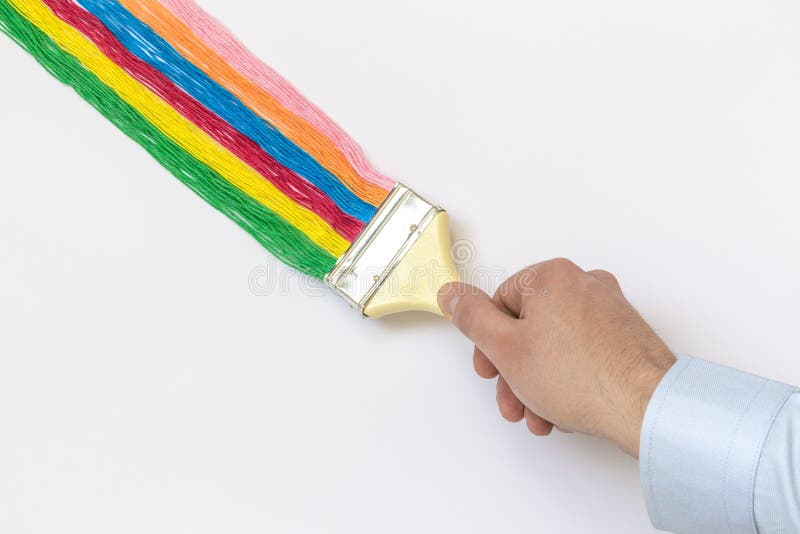 Cierre para arriba del cepillo de la tenencia de la mano del hombre con el hilo multicolor aislado en concepto minimalistic del a fotos de archivo libres de regalías Cierre para arriba del cepillo de la tenencia de la mano del hombre con el hilo multicolor aislado en concepto minimalistic del a fotos de archivo libres de regalías
