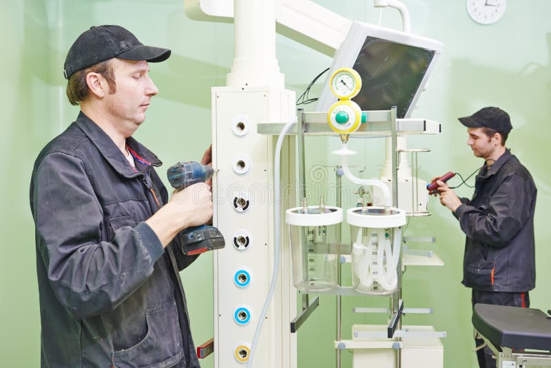 Carpenters joiners with screwdriver mounting equipment at surgery room in clinic. Carpenters joiners with screwdriver mounting equipment at surgery room in clinic