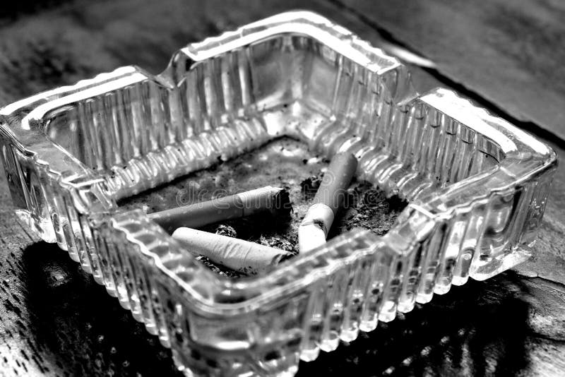 Cigarette in glass ashtray stock image. Image of concept 88112595