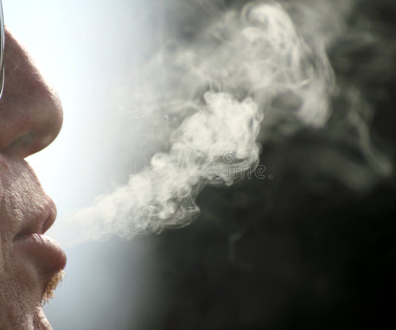 Cigarette Smoke Comes Out Of The Mouth Of The Smoker Man Stock Image