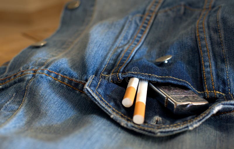 Necessary things for a man, maybe an old date. cigarettes, denim shirt, on a wooden table. Necessary things for a man, maybe an old date. cigarettes, denim shirt, on a wooden table