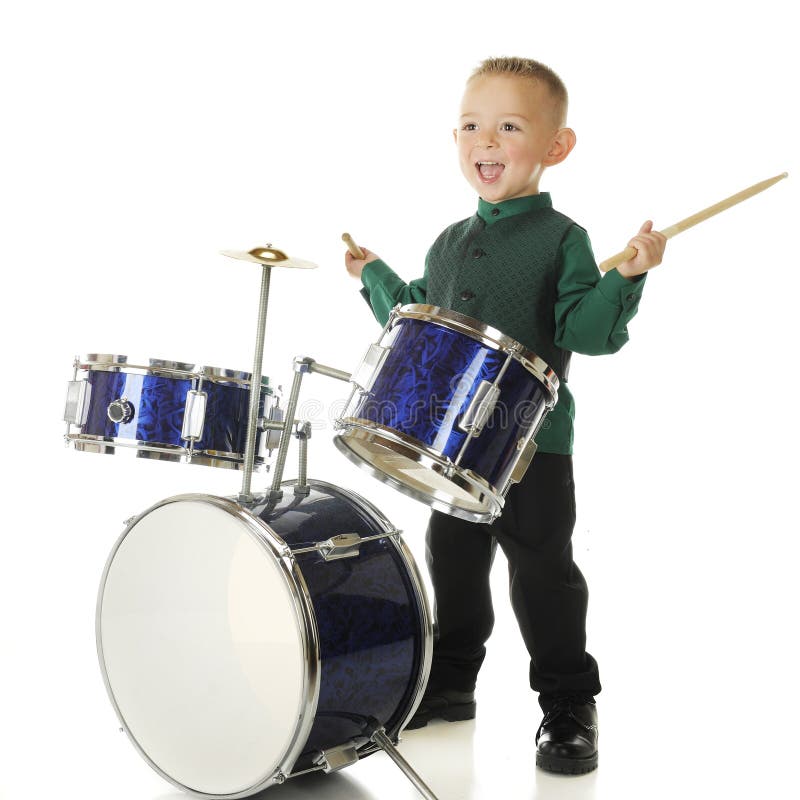 An adorable preschooler delighted to be playing the drums. On a white background. An adorable preschooler delighted to be playing the drums. On a white background.