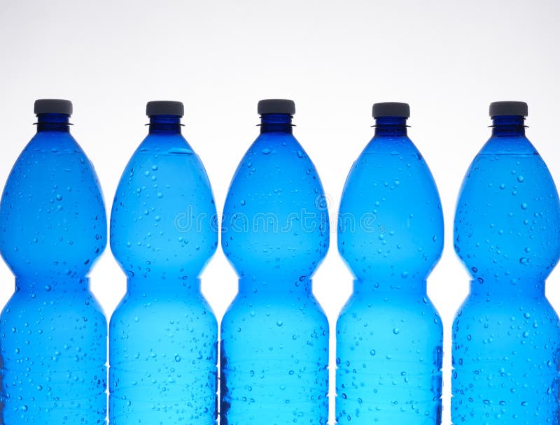 Five blue plastic bottles in a row. Five blue plastic bottles in a row