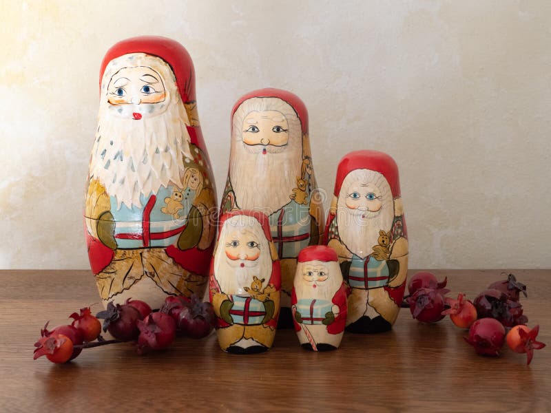Cinco Santa Nesting Dolls de madeira com as bagas que estão em um grupo fotografia de stock royalty free Cinco Santa Nesting Dolls de madeira com as bagas que estão em um grupo fotografia de stock royalty free