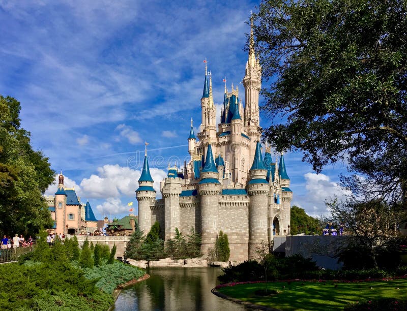 Full view of beautiful Cinderella Castle with river and tree at Walt Disney World theme park Magic Kingdom, Orlando, Florida. It is worldwide recognized icon. 2015. Full view of beautiful Cinderella Castle with river and tree at Walt Disney World theme park Magic Kingdom, Orlando, Florida. It is worldwide recognized icon. 2015