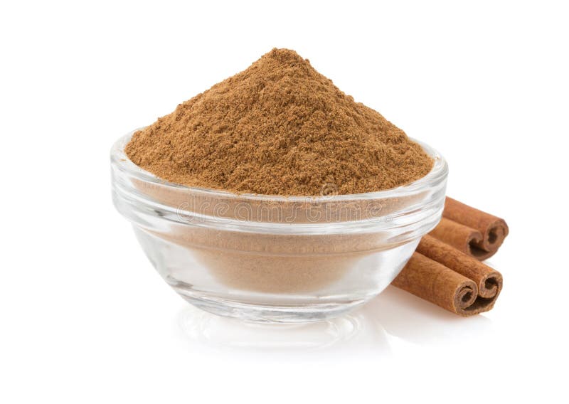 Cinnamon in bowl on white stock photography