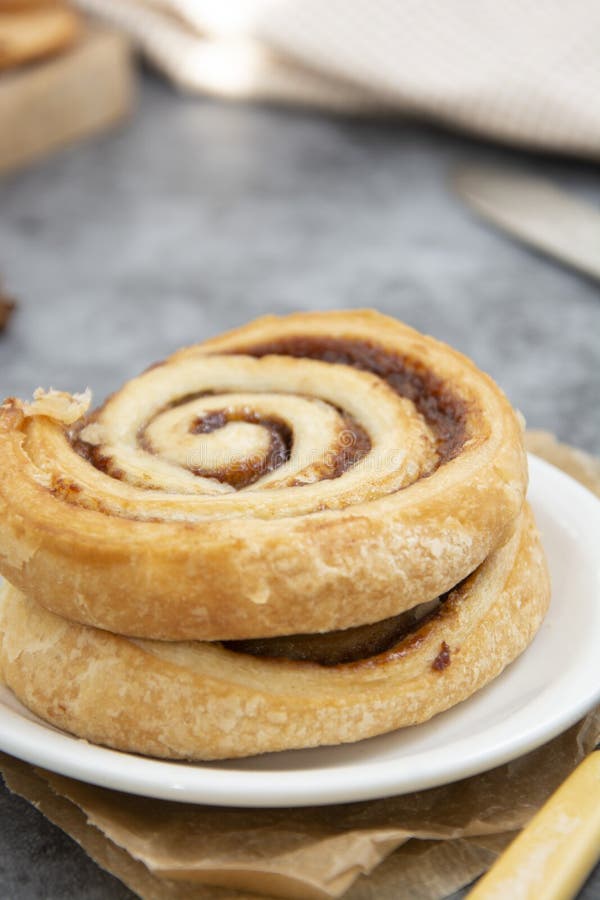 Cinnamon Roll Bun Close Up. Cinnamon Swirl Pastry for Breakfast Over