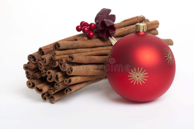 Cinnamon sticks with red christmas tree ball