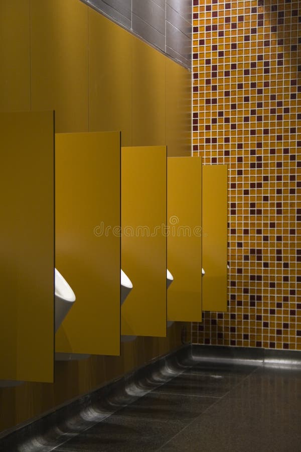 Five urinals in a public restroom. Five urinals in a public restroom