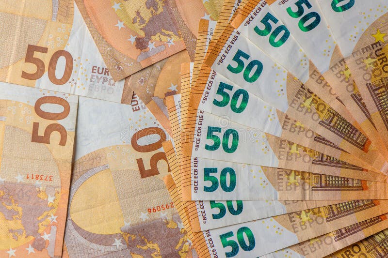 Euro 50 banknotes fanned out on a background of paper bills 8. Euro 50 banknotes fanned out on a background of paper bills 8