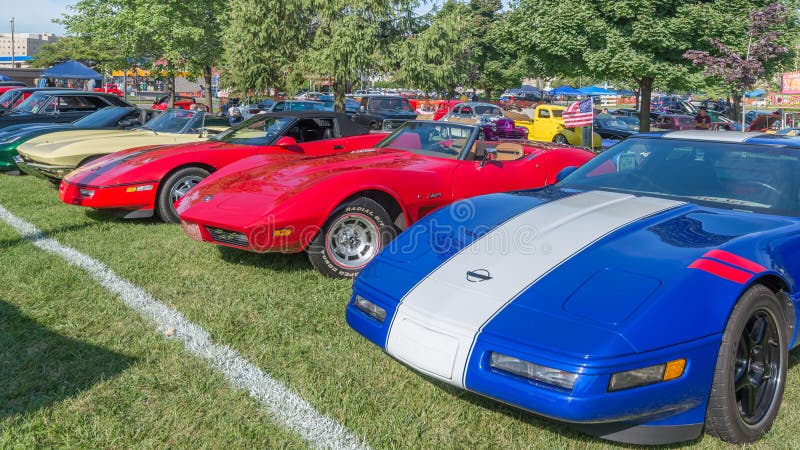 ROYAL OAK, MI/USA - AUGUST 15, 2014: Five Chevrolet Corvette cars at the Woodward Dream Cruise, the world's largest one-day automotive event. Woodward is a National Scenic Byway and Michigan Heritage Route. ROYAL OAK, MI/USA - AUGUST 15, 2014: Five Chevrolet Corvette cars at the Woodward Dream Cruise, the world's largest one-day automotive event. Woodward is a National Scenic Byway and Michigan Heritage Route.
