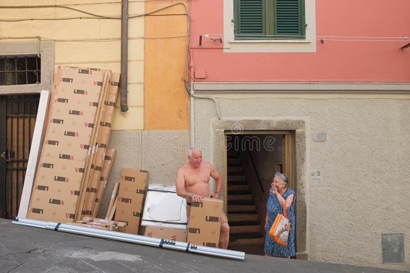 Cinque terre - vecchia coppia di italiani chatta allegramente fuori da una porta aperta a Colombo a riomaggiore, città costiera di immagine stock libera da diritti