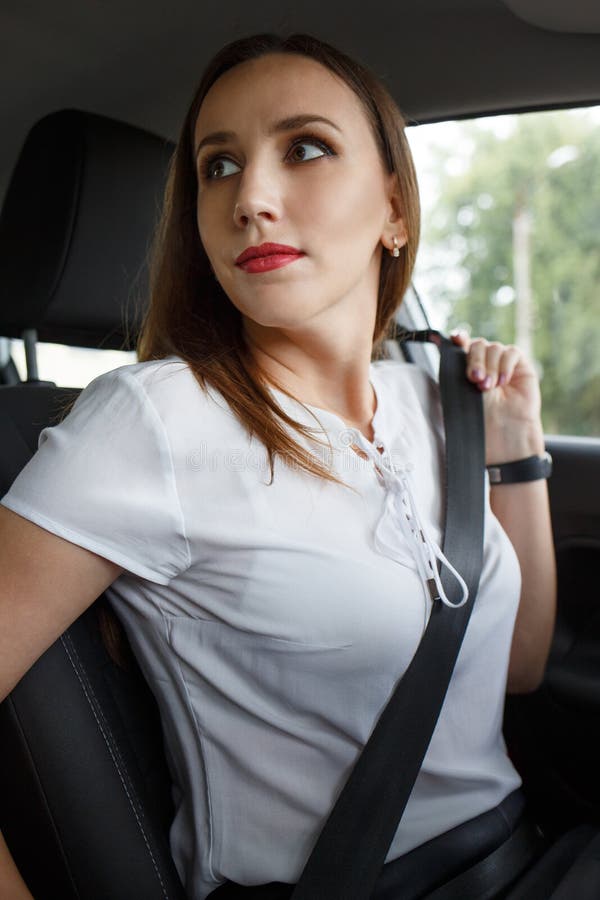 Cinto de segurança da asseguração da jovem mulher no carro imagem de stock Cinto de segurança da asseguração da jovem mulher no carro imagem de stock