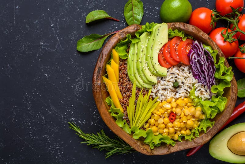 Healthy vegan food bowl with quinoa, wild rice, chickpea, tomatoes, avocado, greens, cabbage, lettuce on black background top view with copy space sport spring salad diet eating fresh lunch nutrition organic vegetable super appetizer dinner meal natural trend vitamin wood bio breast cereals cherry cuisine eco leaves wooden antioxidant greenery farm culinary assorted rustic dieting lowfat protein spinach leafy calorie plant. Healthy vegan food bowl with quinoa, wild rice, chickpea, tomatoes, avocado, greens, cabbage, lettuce on black background top view with copy space sport spring salad diet eating fresh lunch nutrition organic vegetable super appetizer dinner meal natural trend vitamin wood bio breast cereals cherry cuisine eco leaves wooden antioxidant greenery farm culinary assorted rustic dieting lowfat protein spinach leafy calorie plant