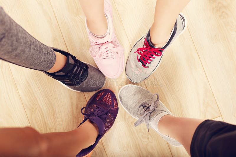 Circle of female legs with shoes in a gym. Circle of female legs with shoes in a gym