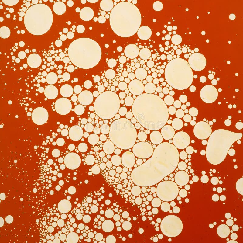 Abstract art design of circles in red paint.