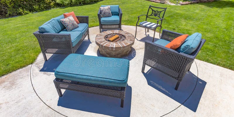 Circular fire pit and chairs on a sunny backyard royalty free stock photography
