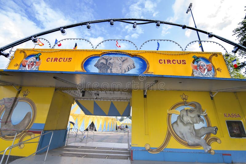 Blue and yellow striped circus tents under a blue sky. Blue and yellow striped circus tents under a blue sky