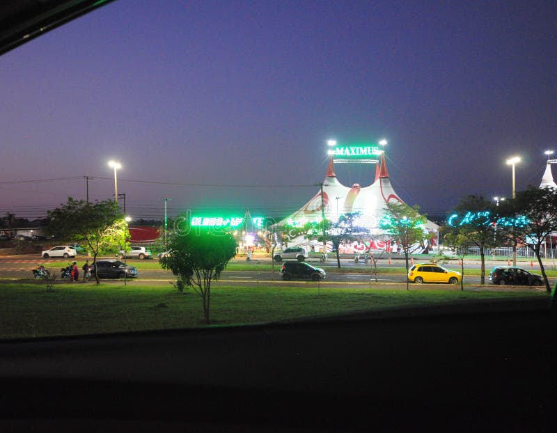 Circus tent with shows at night in an urban area of the city with cars and lights. Circus tent with shows at night in an urban area of the city with cars and lights