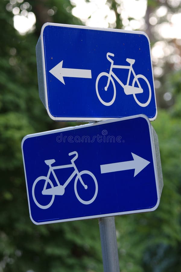 Blue cycling road signs in two directions. Blue cycling road signs in two directions.