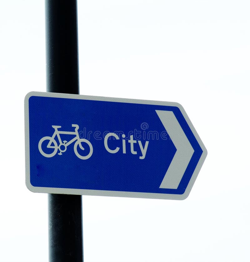 A Cycle way sign pointing towards city on white background suitable for cut out. A Cycle way sign pointing towards city on white background suitable for cut out