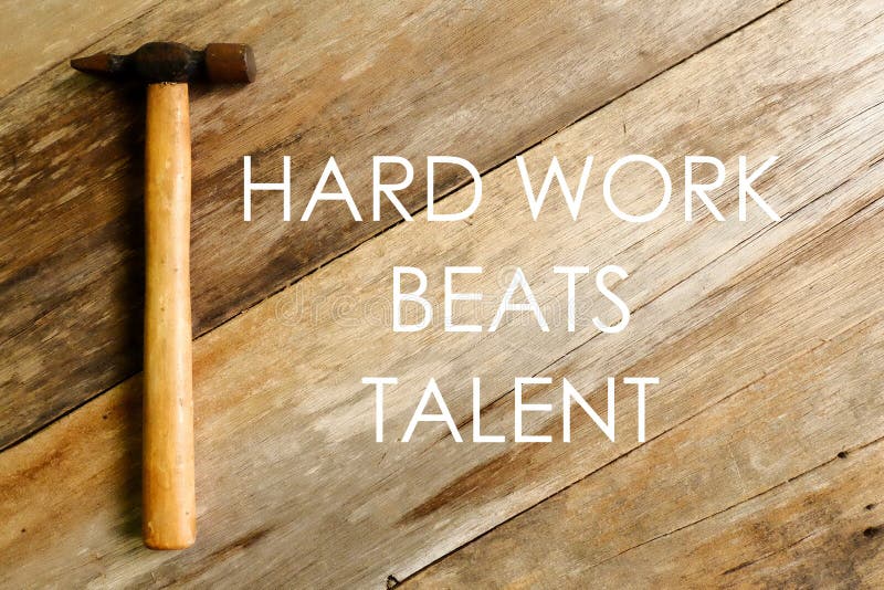 Citations inspirées et de motivation Le dur labeur bat le talent Marteau sur le fond en bois photographie stock Citations inspirées et de motivation Le dur labeur bat le talent Marteau sur le fond en bois photographie stock