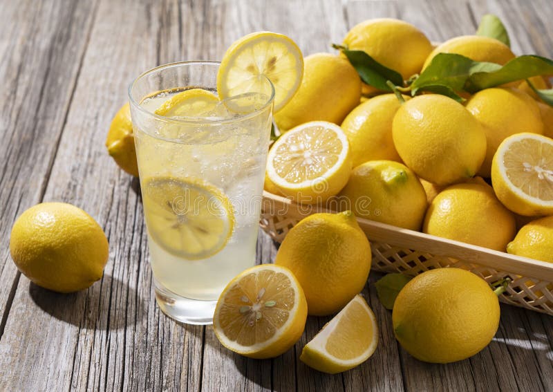 Lots of lemons and lemon sours in a basket on a wooden background. Lots of lemons and lemon sours in a basket on a wooden background