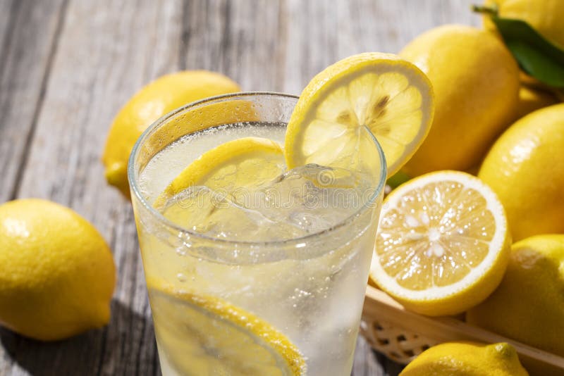 Lots of lemons and lemon sours in a basket on a wooden background. Lots of lemons and lemon sours in a basket on a wooden background