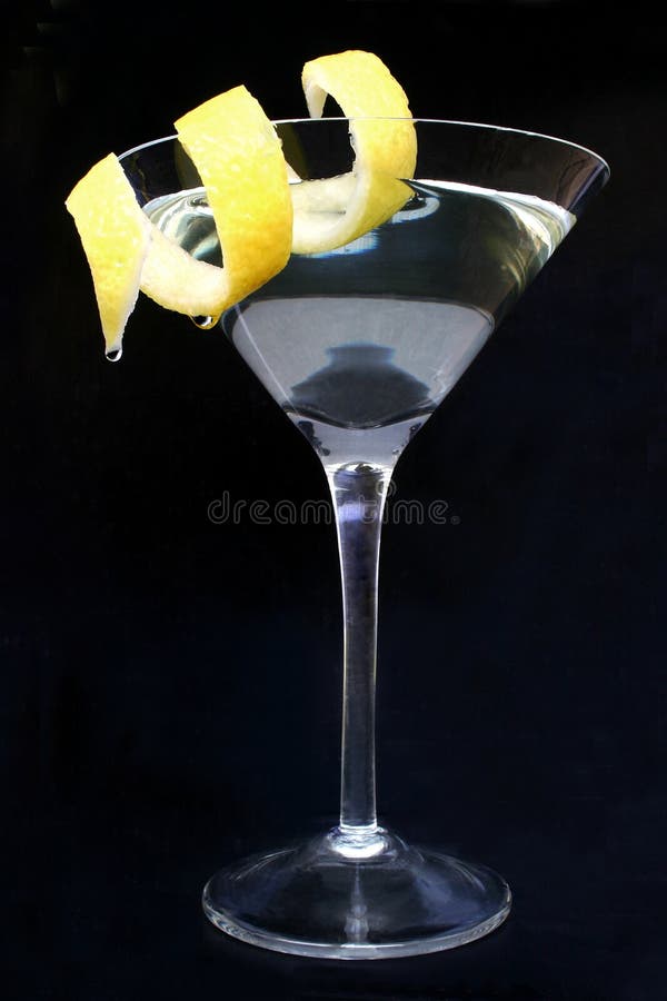 Citrus cocktail with drops hanging from lemon peel twist