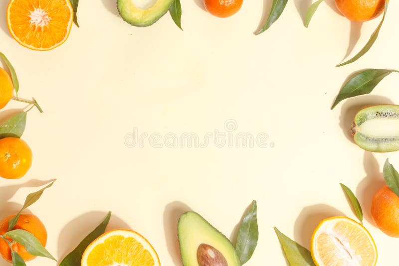 Citrus food on ligth-yellow background - assorted citrus fruits with mint leaves. Top view