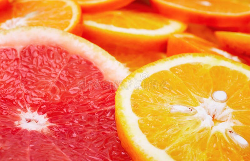 Sliced citrus fruits background closeup