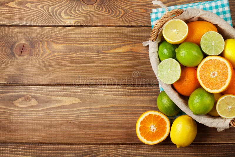 Citrus fruits in basket. Oranges, limes and lemons