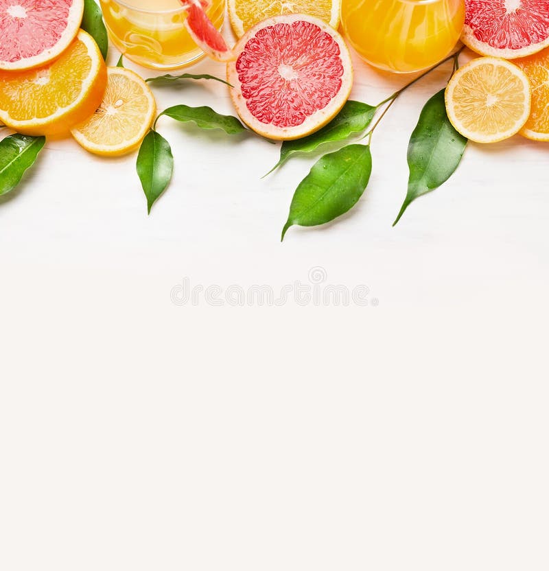 Citrus fruits slices frame on white wooden background stock photo Citrus fruits slices frame on white wooden background stock photo