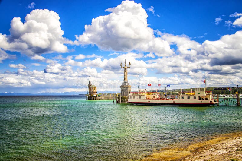 The city Constance on the Lake Constace, Bodensee. The view from the ship on the port with big statue and lighthouse. The city