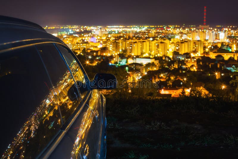 Luci della città riflesse in auto durante la notte.