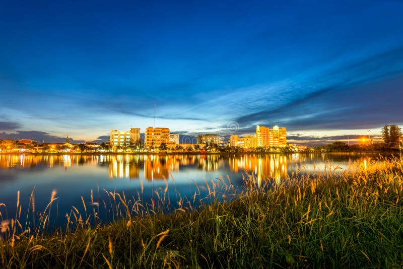 city at night with reflection of skyline in the lake