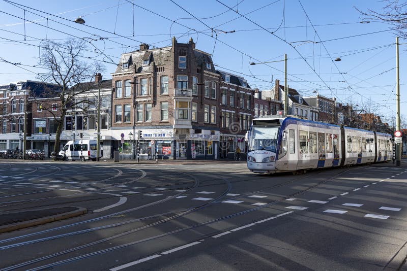 City tram running a on road towards the platform