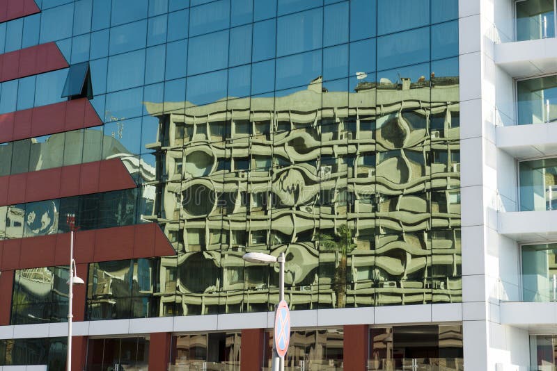 Urban city landscape abstract background concept. Buildings are reflected in the windows of a modern glass office building. Urban city landscape abstract background concept. Buildings are reflected in the windows of a modern glass office building.