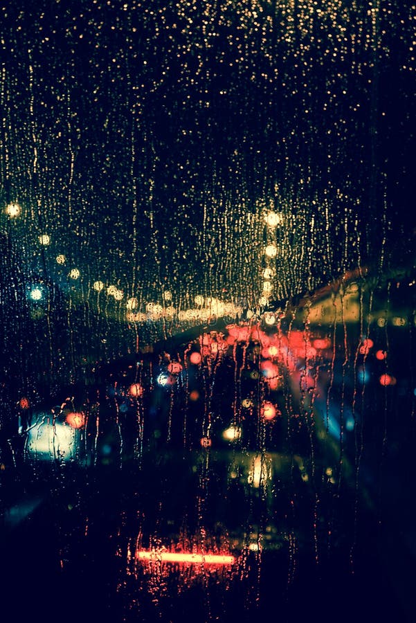 City view through a window on a rainy night