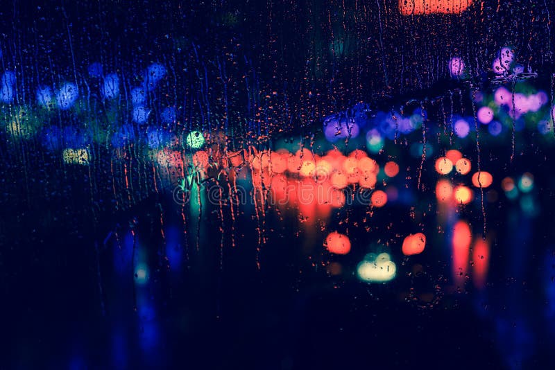City view through a window on a rainy night