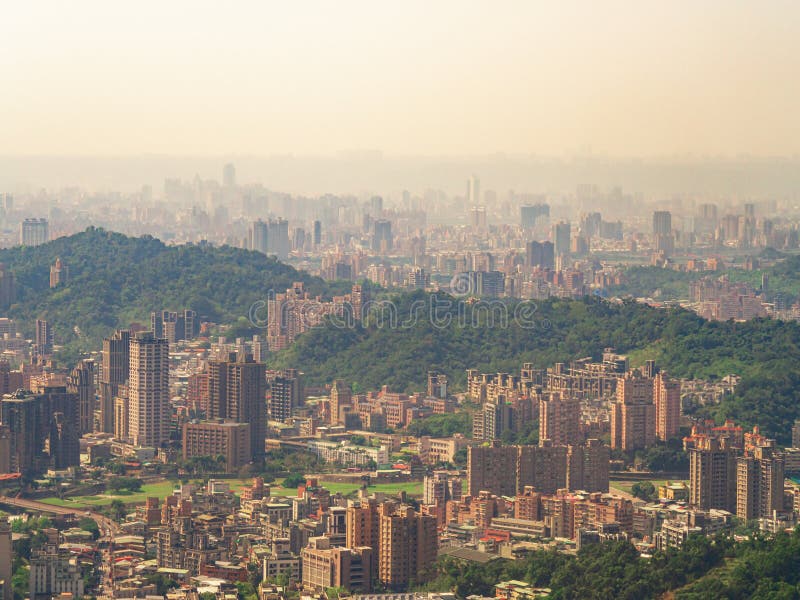 Cityscape of Taipei city in the fog with golden sunlight from Maokong Gondola. royalty free stock photo Cityscape of Taipei city in the fog with golden sunlight from Maokong Gondola. royalty free stock photo