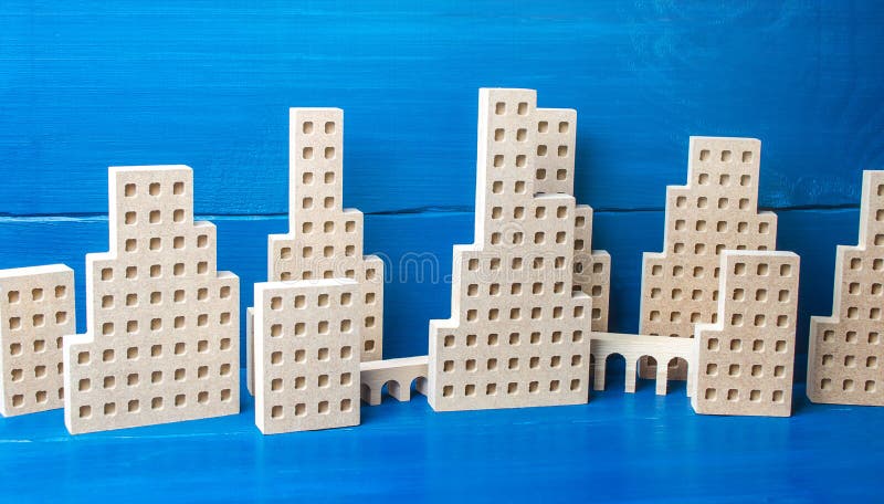 City of figures of buildings on a blue background. Concept for real estate, urban environment and transport infrastructure. City management and planning. Construction industry, growth and development. City of figures of buildings on a blue background. Concept for real estate, urban environment and transport infrastructure. City management and planning. Construction industry, growth and development