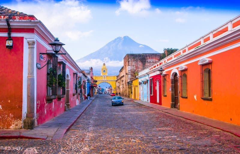 Ciudad de Guatemala, Guatemala, April, 25, 2018: Cityscape in the main street of Antigua city with the Agua volcano in the background, Guatemala. Ciudad de Guatemala, Guatemala, April, 25, 2018: Cityscape in the main street of Antigua city with the Agua volcano in the background, Guatemala.