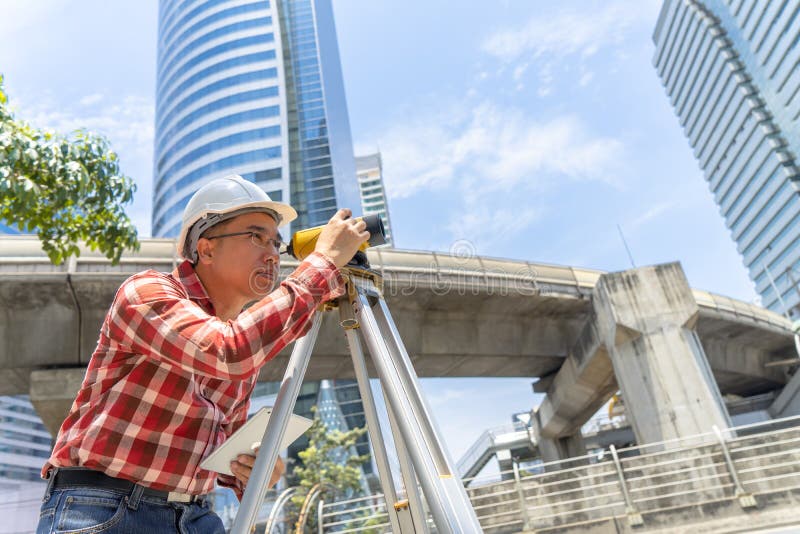 Civil engineer land survey with tacheometer or theodolite equipment. Worker Checking construction site on the road. Surveyor engineer making measuring with theodolite instrument level tool