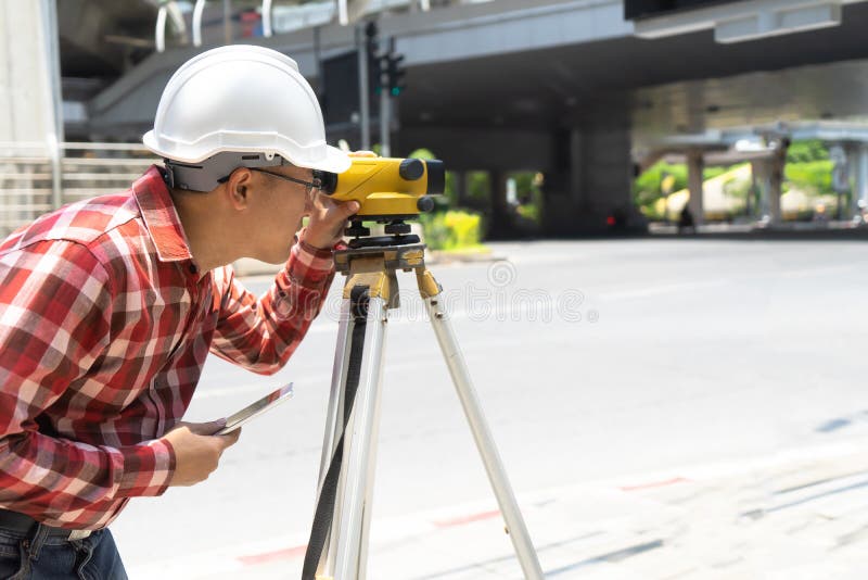Civil engineer land survey with tacheometer or theodolite equipment. worker Checking construction site on the road. Surveyor engineer making measuring with theodolite instrument level tool