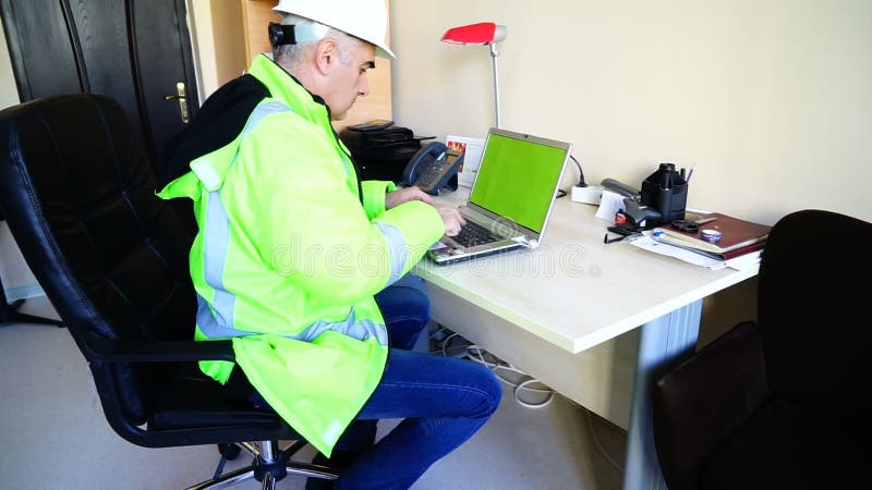 Civil Engineer in Overalls Working at Office with Laptop Stock Footage -  Video of buildings, foreman: 74641976