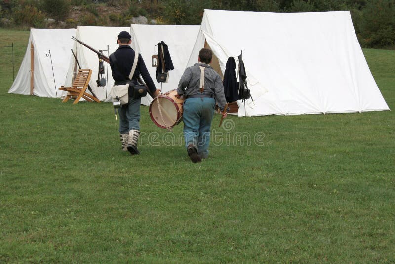 These two boys are part of a Civil War Reenactment. These two boys are part of a Civil War Reenactment.